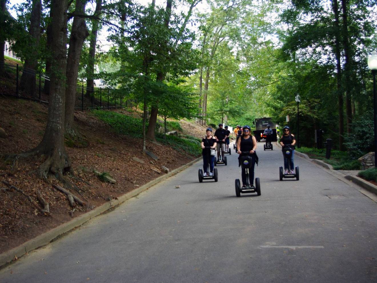 a group of people riding bikes down a street