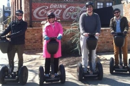 a group of people riding on the back of a motorcycle