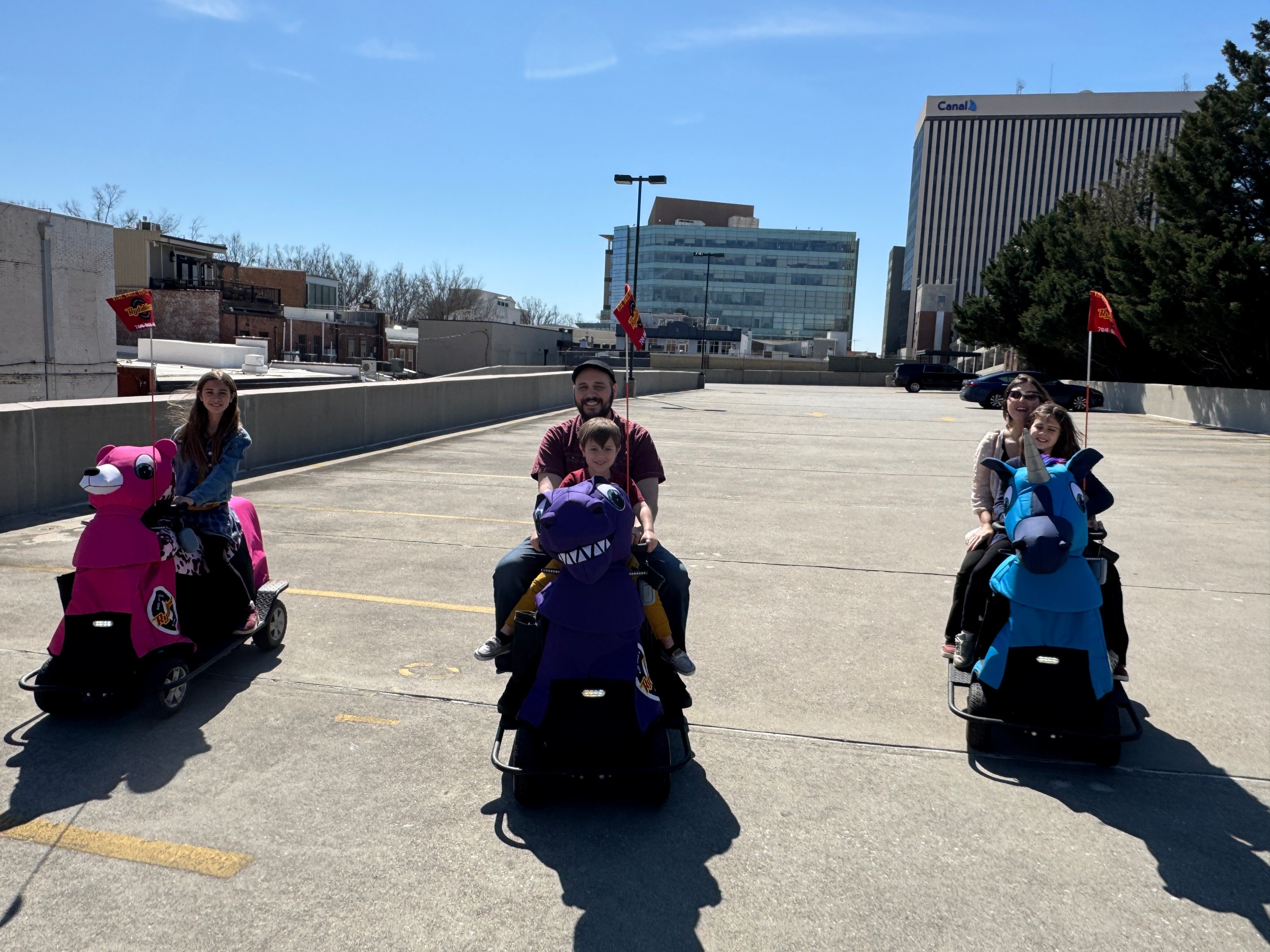 a group of people sitting in a parking lot