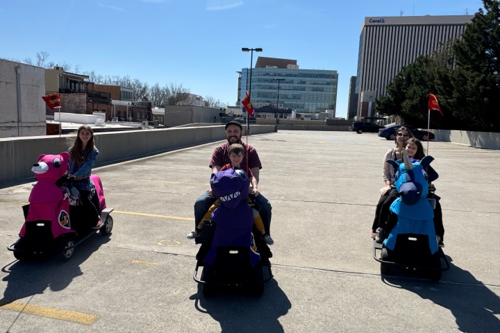 a group of people sitting in a parking lot