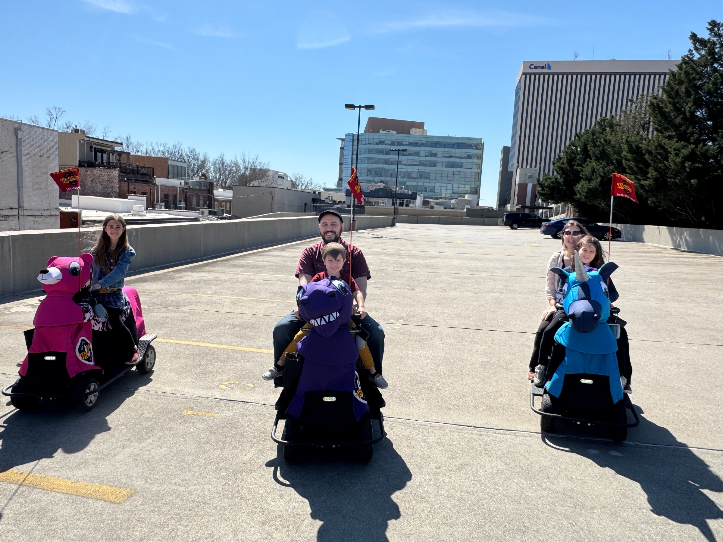 a group of people sitting in a parking lot