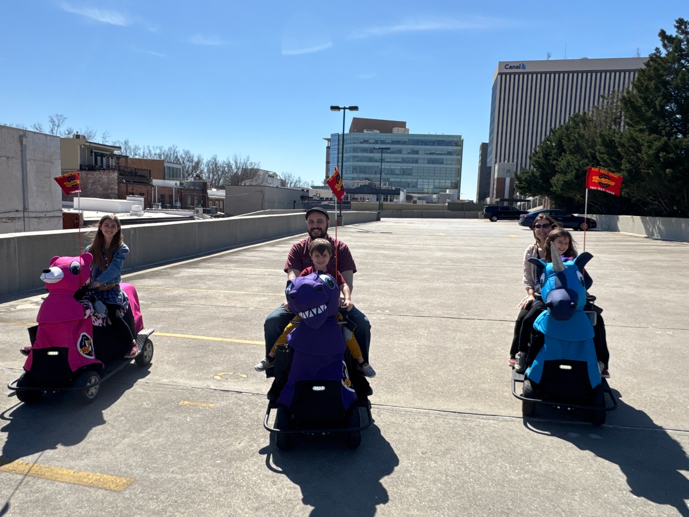 a group of people sitting in a parking lot