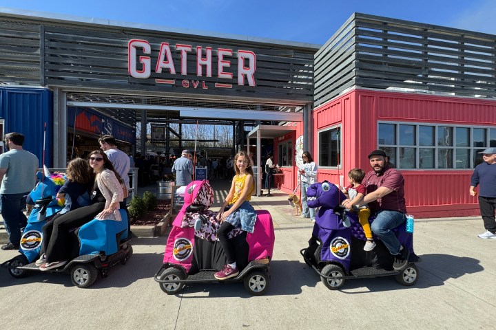 a group of people sitting in a parking lot