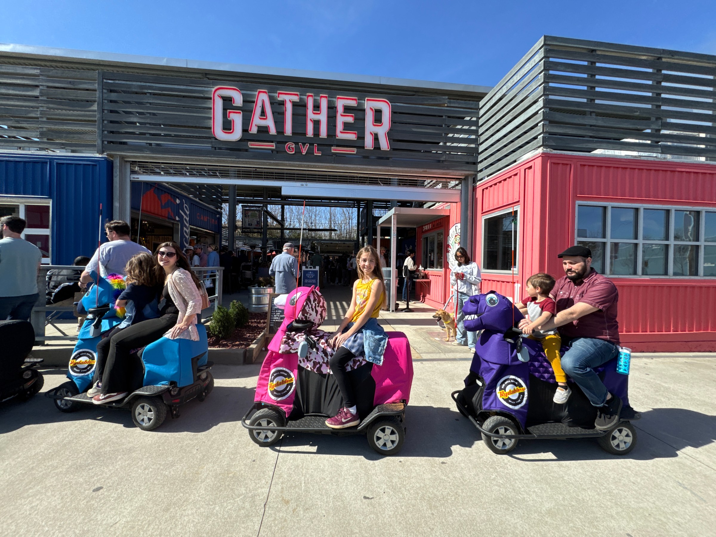 a group of people sitting in a parking lot