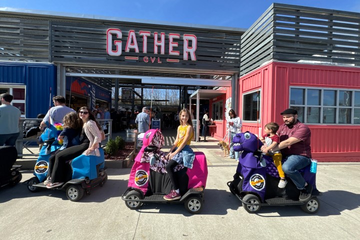 a group of people sitting in a parking lot