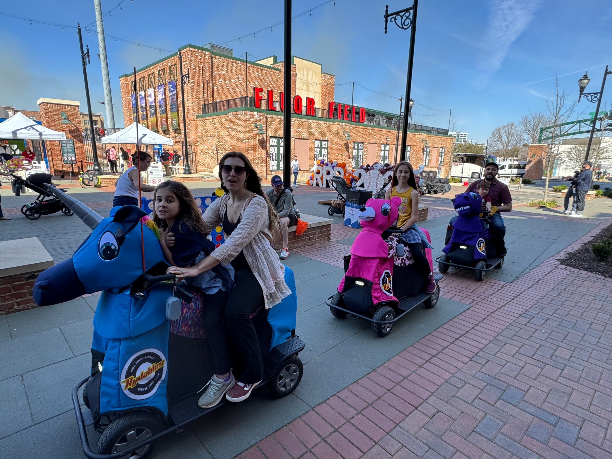 a group of people sitting on the side of the street
