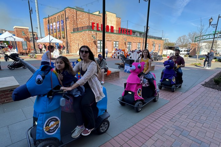 a group of people sitting on the side of the street