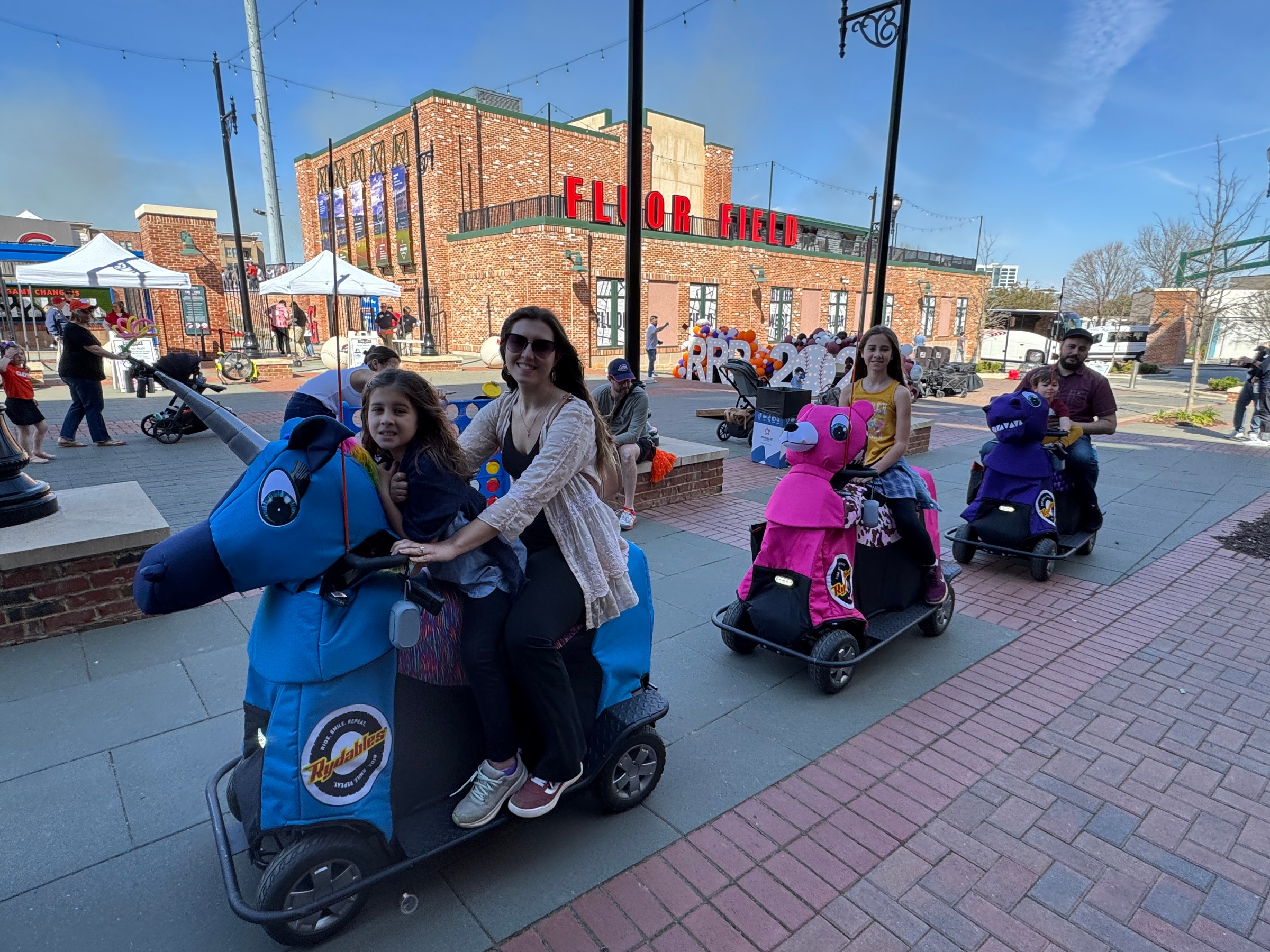 a group of people sitting on the side of a road