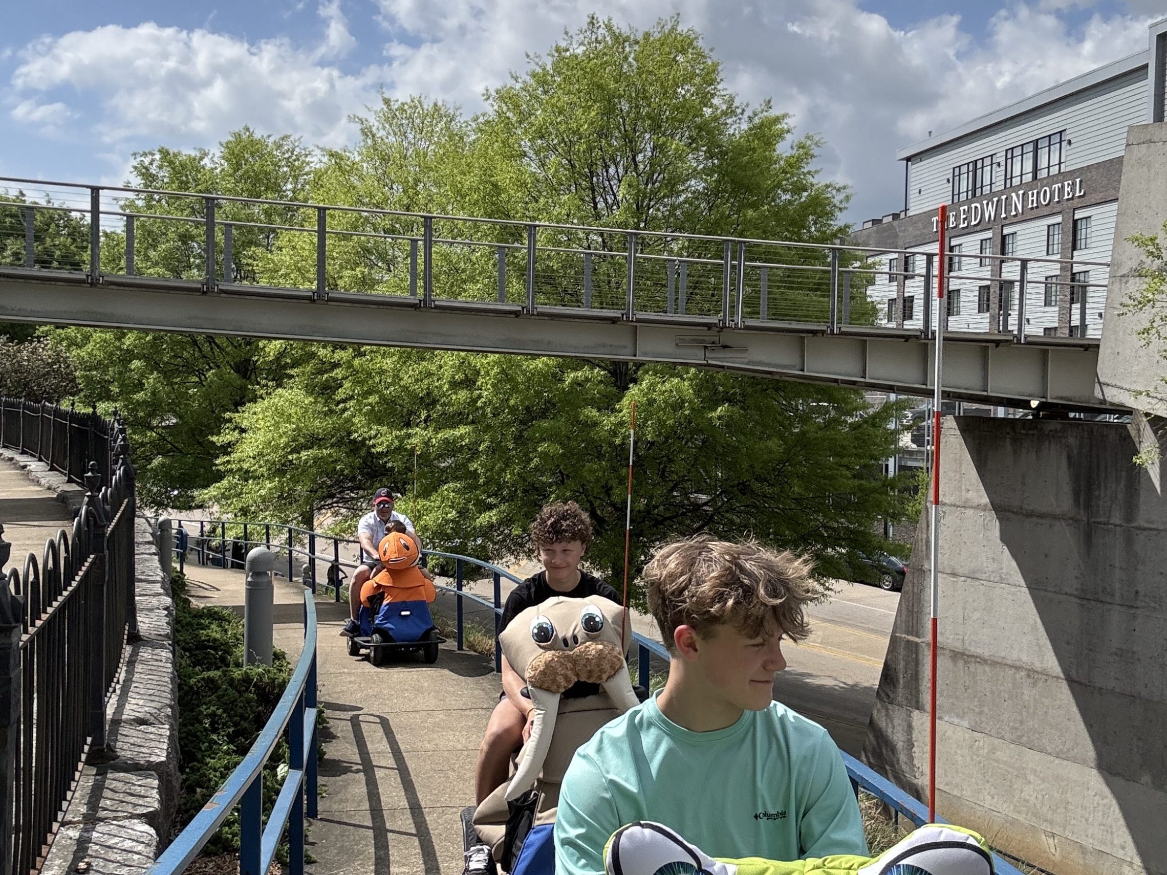 a group of people walking on a bridge